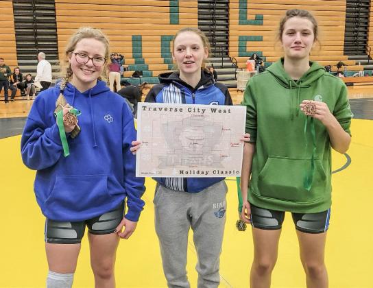 Gladwin’s (left to right) Jade Sheltraw, Tricia Pyrzewski and Charlotte Mawhorter show off their awards after competing at a girls’ only invitational at Traverse City West last week.